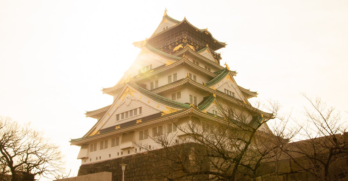 A clock tower in front of Osaka Castle