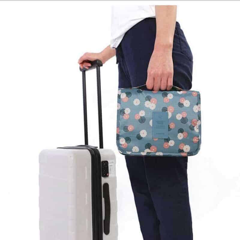 A person holding a piece of luggage